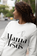 Woman wearing a white sweatshirt with 'This Mama Walks with Jesus' text.
