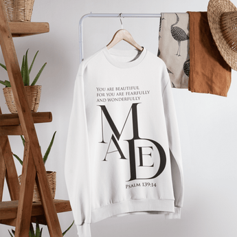White sweatshirt with text and logo on a hanger against a neutral background