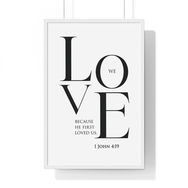 We Love framed Christian wall art inspired by 1 John 4:19, white frame with black and white scripture typography