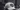 White cap with 'DAD' printed on a heart-shaped design in a blurred indoor setting