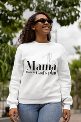 Woman wearing a white sweatshirt with text, standing outdoors with greenery in the background