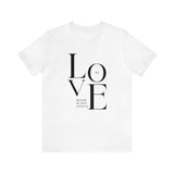 We Love Because He First Loved Us Christian T-Shirt — 1 John 4:19 in white